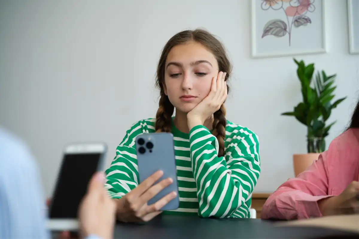 Young woman using a smartphone while shopping online, highlighting how Gen Z discovers and engages with brands digitally.